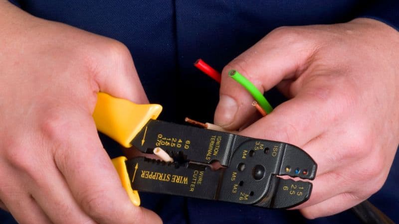 wire stripper in the hands of worker