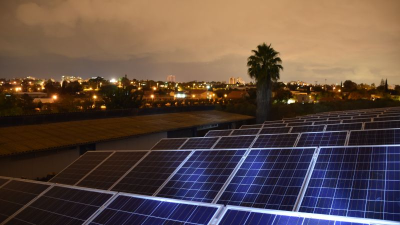 Solar panel array at dusk promoting renewable energy and sustainable living.